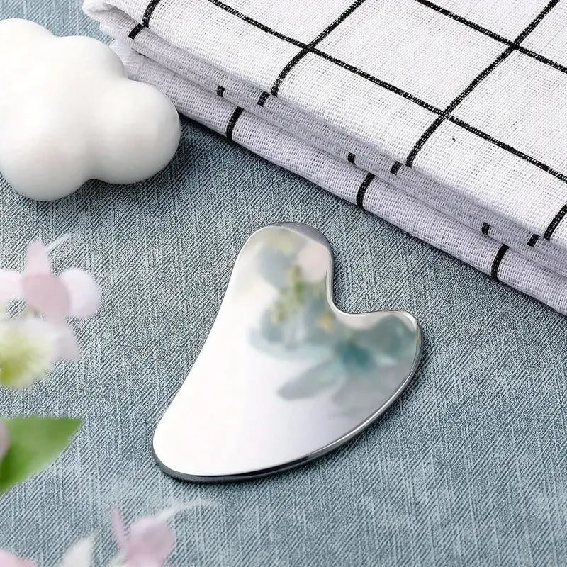 "Heart-Shaped Stainless Steel Gua Sha Tool: Relaxing Facial & Body Massager with Travel Pouch"